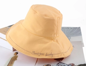 Minimalist beige canvas bucket hat with Seek your beauty embroidery for summer sun protection
