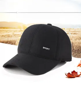 Close-up of winter wool baseball cap with ear flaps and metal sport emblem detail