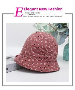 Detail of burgundy floral sun hat with daisy print and elegant pleated fabric design