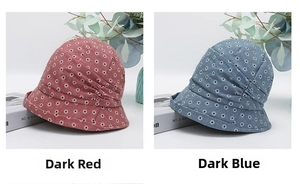 Close-up of foldable bucket hats with daisy prints in deep red and dark blue colors