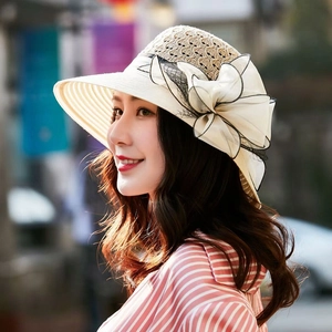 Detail of hand-woven straw hat featuring a large elegant mesh bow and breathable openwork