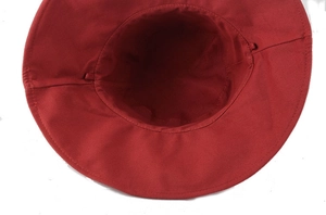 Detail view of the red cotton bucket hat interior showing stitching and windproof rope loops