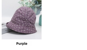 Detail of purple floral bucket hat with white daisy patterns and textured cotton fabric
