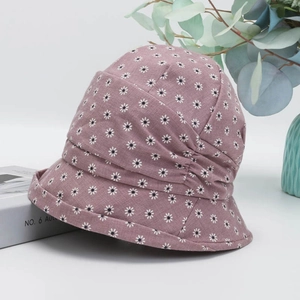 Detail of floral purple bucket hat with daisy print and elegant pleated cotton texture