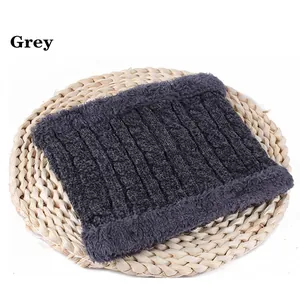 Detail of dark grey cable knit neck warmer with thick thermal lining on woven mat