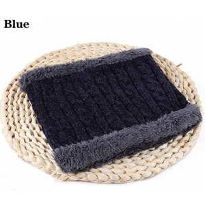 Detail of chenille neck gaiter showing blue cable knit exterior and plush gray lining
