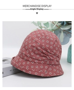 Close-up of pink sun hat with white daisy print and stylish pleated texture detail