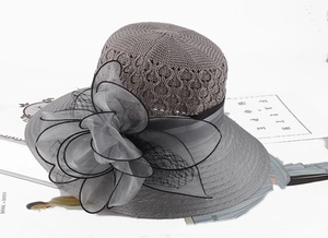 Close-up of elegant grey knitted sun hat with large sheer decorative floral detail