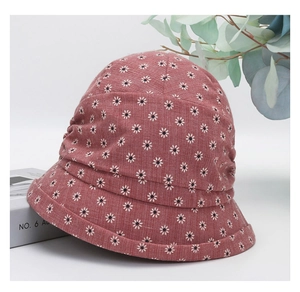 Detail of floral sun hat with daisy print and elegant pleated crown for women