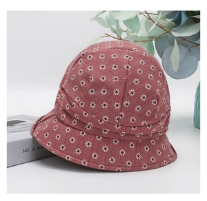 Detailed view of women's floral bucket hat with daisy print and pleated fabric design