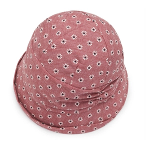 Detail of dusty rose floral sun hat showing textured cotton fabric and daisy print