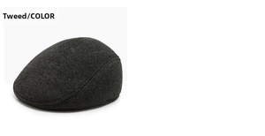 Detailed view of the dark grey herringbone fabric on a winter duckbill flat cap for men