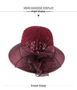 Detail of burgundy knitted sun hat featuring elegant large mesh floral decoration