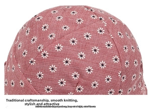 Macro shot of embroidered daisy pattern on terracotta foldable sun hat fabric texture