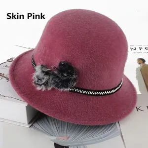 Elegant dusty pink winter cloche hat for women with faux fur pom-poms and bow detail