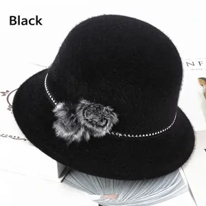 Chic black faux mink fur bucket hat for women with pompom accents and geometric band