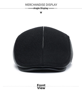 Front detail of black winter flat cap with thick wool fabric and leather brim