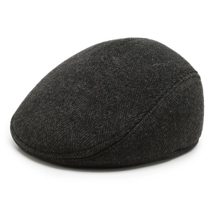 Detail of dark grey herringbone wool newsboy cap showing texture and fine stitching