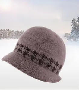 Close-up of lilac knitted winter hat with plaid decorative band and thick faux fur texture