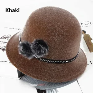 Detailed texture of khaki faux fur cloche hat with fuzzy pom-poms and wave ribbon