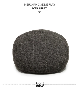 Front view detail of a classic plaid winter flat cap made of thick tweed wool for men
