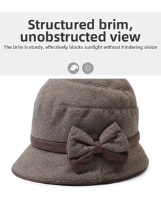 Close-up of herringbone texture and bow detail on a brown wool cloche hat for women