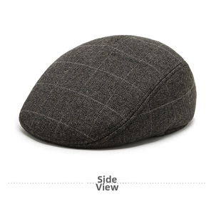 Detail view of winter brown plaid flat cap featuring warm wool tweed fabric for men