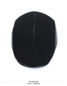 Overhead view of a black men's winter newsboy cap showing wool fabric and leather seam details