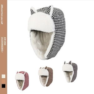 Detailed view of houndstooth trapper hat with cat ears and soft faux fur lining