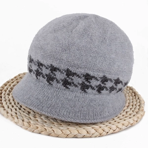 Detail of grey knitted hat with plush wool texture and decorative jacquard pattern