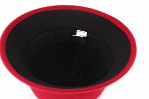 Detail of red faux mink winter hat featuring black lining with adjustable drawstring