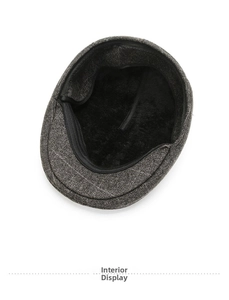 Detailed close-up of the thick black plush lining inside the warm grey wool newsboy cap