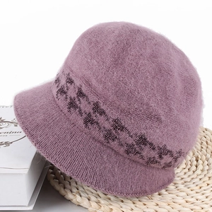 Detailed texture of purple faux rabbit fur winter hat with glitter decorative band