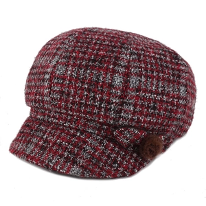 Winter tweed newsboy cap in red and black plaid with a brown faux fur pom-pom detail
