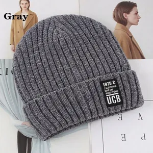 Close-up of a dark grey chunky knit beanie featuring a vintage California Dream woven label