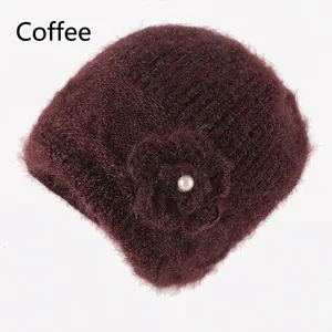 Detailed close-up of coffee brown knit hat featuring a fuzzy texture and pearl flower detail