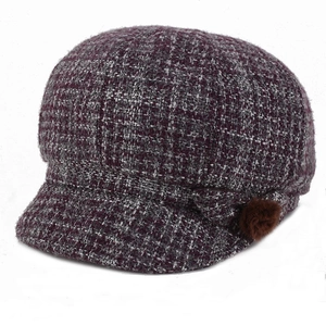 Detail of purple tweed newsboy cap with warm padded lining and side fur pompom decor