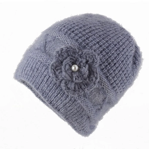 Detail shot of winter beanie showing knit texture and decorative flower with pearl