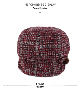 Front view of a red and black tweed newsboy cap featuring a textured knit and plush pom-pom