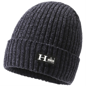 Macro detail of dark grey ribbed knit beanie with soft chenille texture and brand label