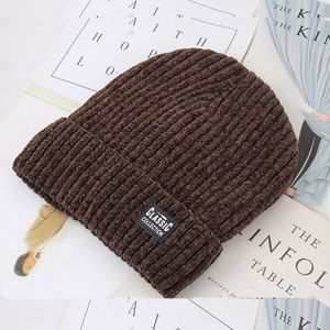 Detailed texture of dark brown ribbed knit beanie with Classic Collection patch