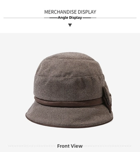 Detailed view of women's cloche hat with herringbone pattern and side bow decoration