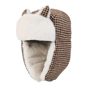 Detail of winter trapper hat with houndstooth pattern and plush faux fur ear flaps