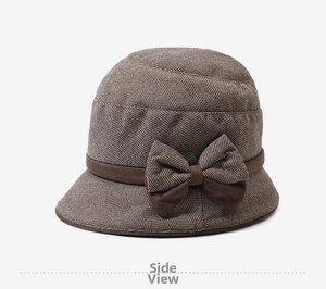 Detail view of the brown wool cloche hat with herringbone texture and ribbon bow
