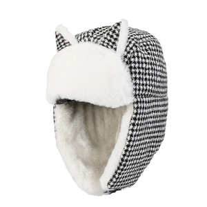 Detail of winter ushanka hat with black and white houndstooth pattern and cute cat ears