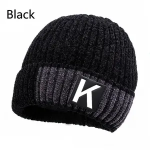 Detail of black winter knit beanie with soft chenille texture and grey accent stripe