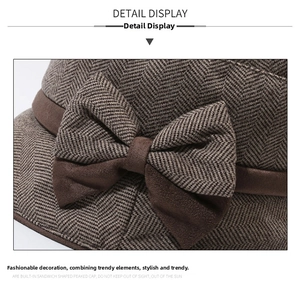Detailed view of coffee herringbone wool bucket hat with elegant bow embellishment