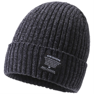 Detailed view of the dark grey ribbed knit beanie showing soft texture and textile label