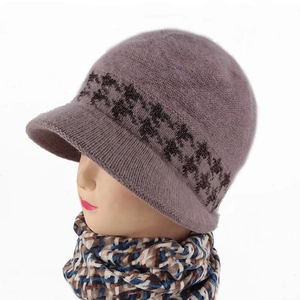 Detail of winter plush knit brimmed hat with floral print and matching plaid scarf set