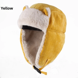 Detail of yellow corduroy trapper hat featuring soft faux fur lining and cute ear accents